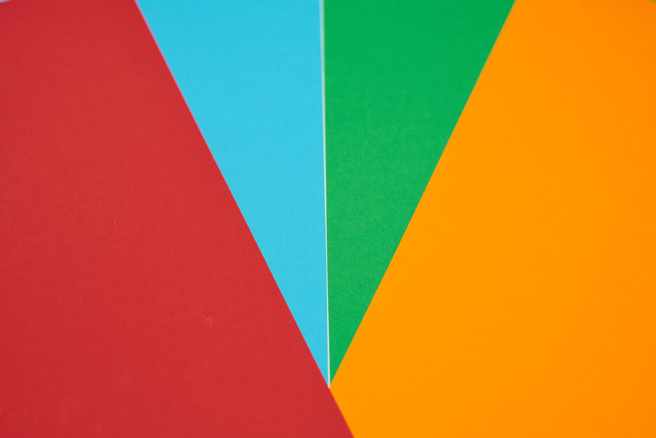 services-03 Colorful abstract design featuring red, blue, green, and orange geometric shapes.