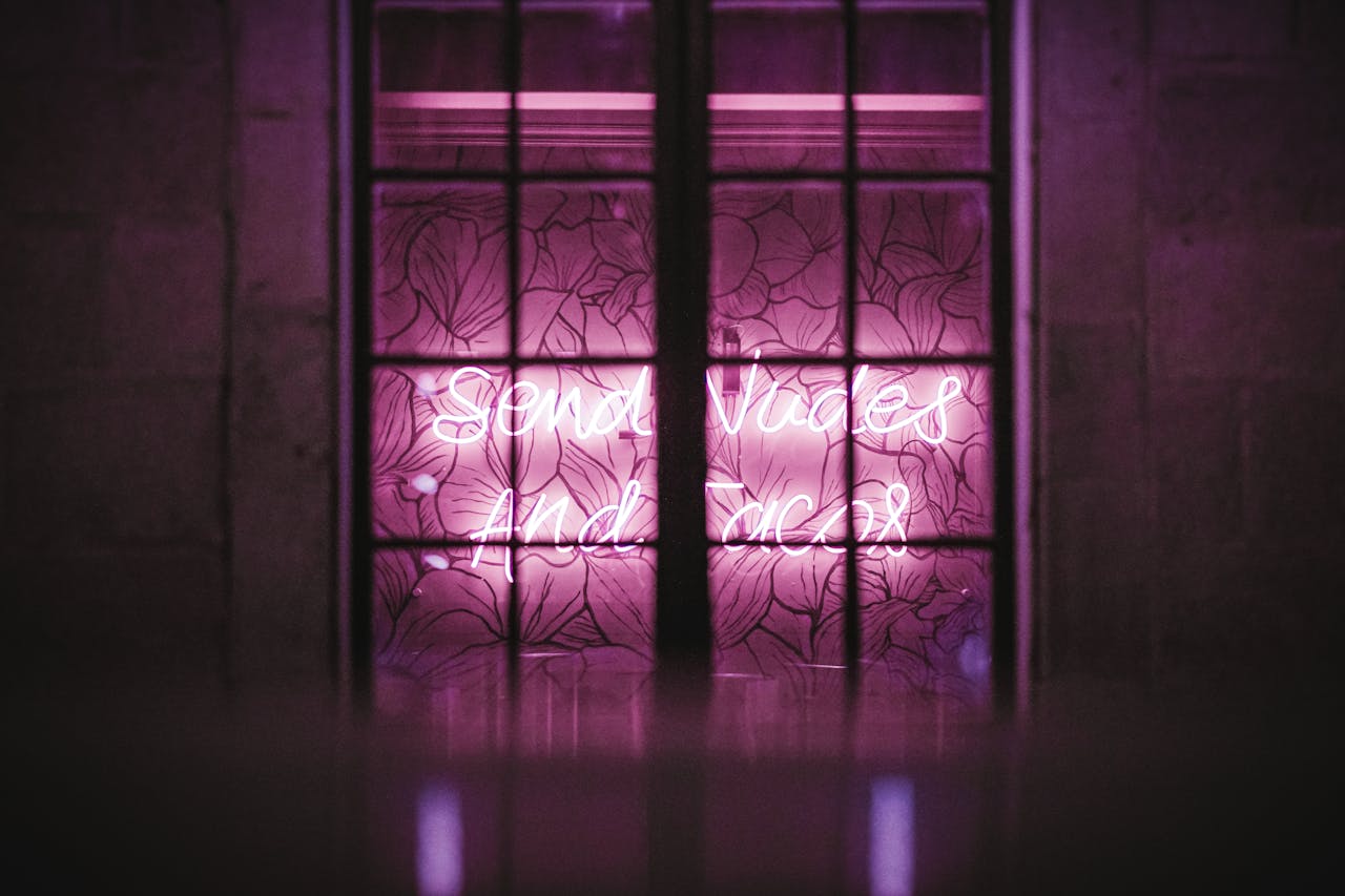 services-01 Bright pink neon lighting behind a decorative window frame adds an urban artistic touch.